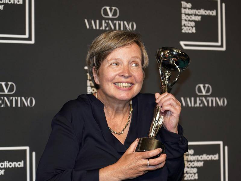Jenny Erpenbeck, author of Kairos, holds the trophy after winning the International Booker Prize. (AP PHOTO)